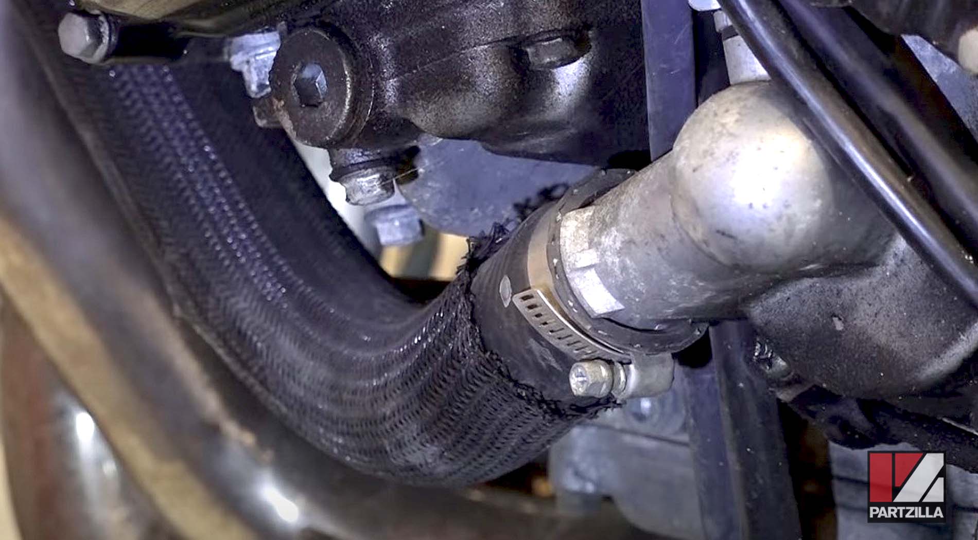 Motorcycle coolant leak causes radiator hose