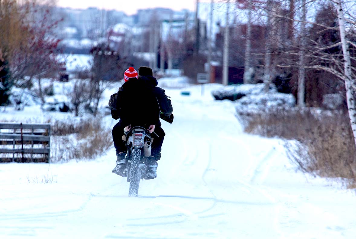 Motorcycle riding on snowy road