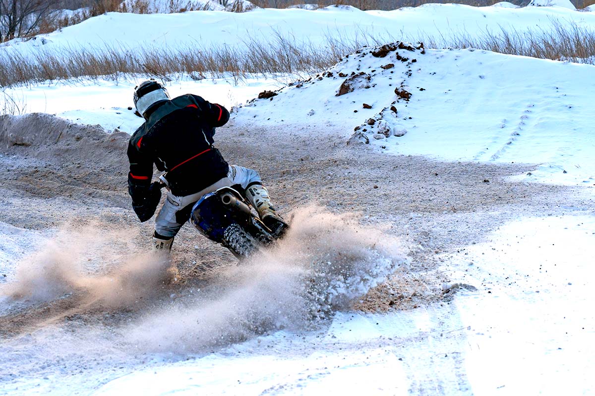 Motorcycle riding in snow hard turn