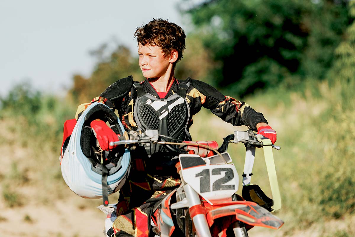 Kid posing on a dirt bike